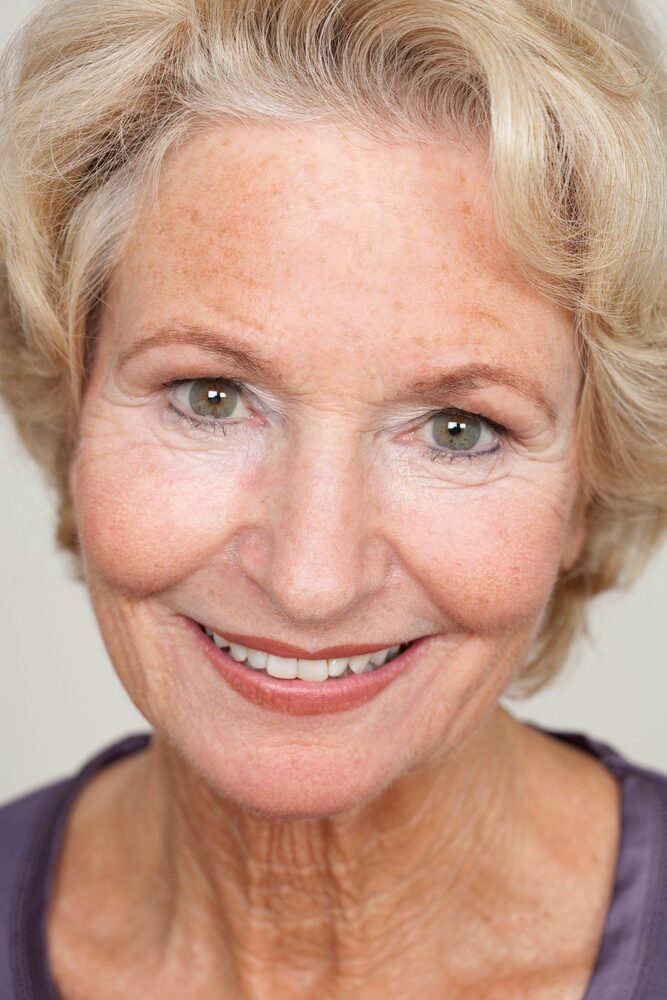 A warm portrait of an elderly woman, the kind of quiet joy that makes early signs so easy to miss.